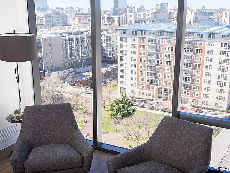 Floor to ceiling windows overlooking a lush courtyard area
