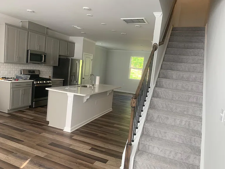 Kitchen Island along with carpeted steps to 3rd floor.