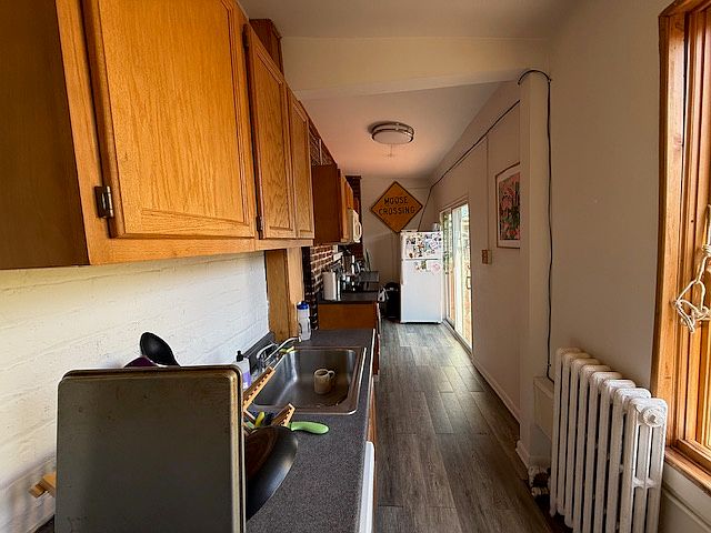 Kitchen - Looking across with the sliding door to the deck at the back on the right-hand side