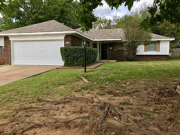 Front yard from street. Features large and established shade tree