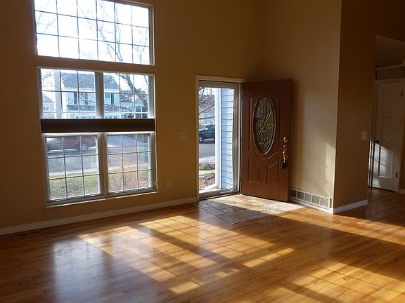 Front entry viewed from corner of family room features plenty of natural light. Storm door includes both glass and screen inserts. Interior paint is been updated and is currently white.