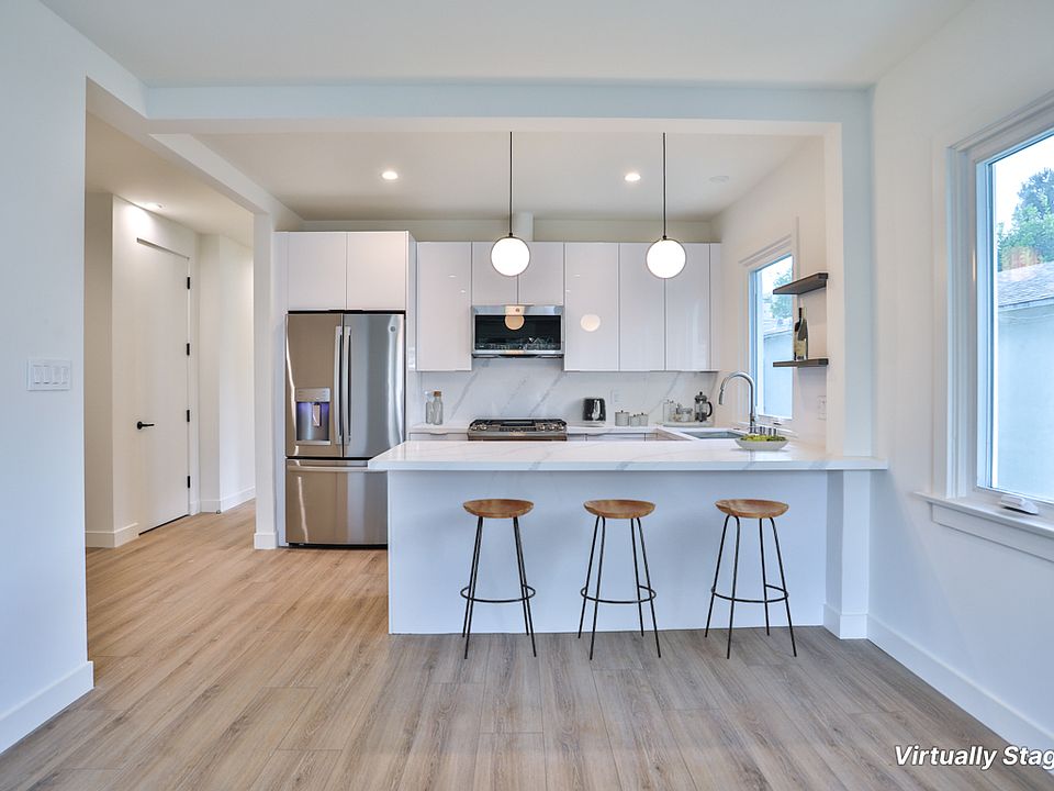 Kitchen featuring stainless steel appliances and peninsula seating