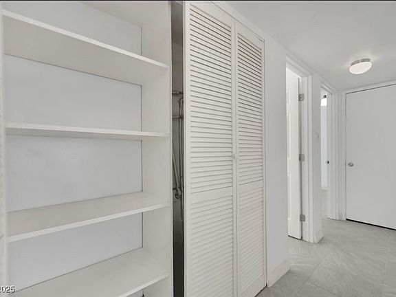 hallway including closet with shelving