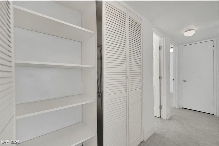 hallway including closet with shelving