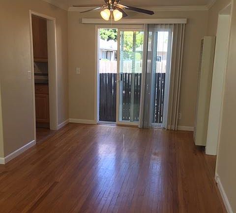 view of dining area with ceiling fan and glass sliding door to back patio