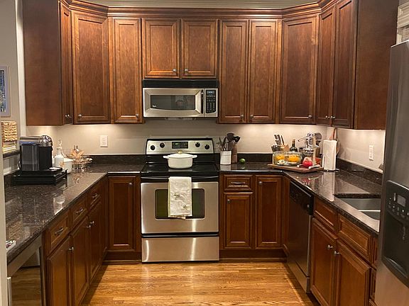 Kitchen with granite countertops, wine fridge, and stainless steel appliances