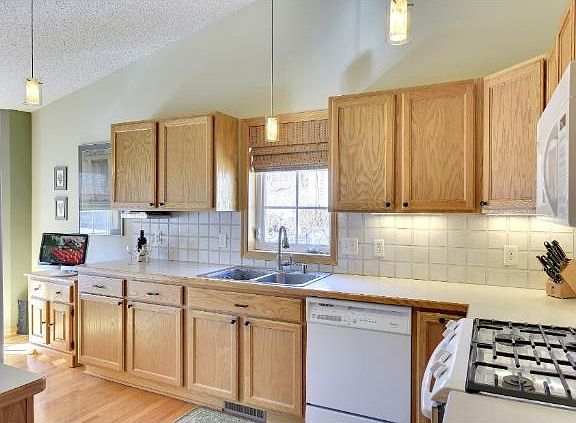 Kitchen is vaulted, sunny and has gorgeous hardwood floors.