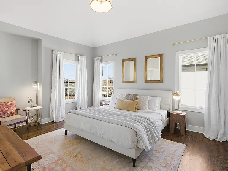 Primary bedroom on the 3rd floor with a king bed, Smart TV, ensuite bath, and room darkening shades. Includes a large walk-in closet. Tastefully decorated with high-end modern furnishings.