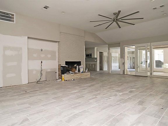 The Family Room has high ceilings, Fireplace and overlooks the pool area, extra study/playroom