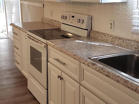 New white cabinets in kitchen and baths