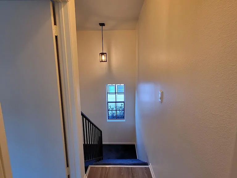 Exit from Bedroom #2, entry to Bdrm #1 on left & stairs to Living areas