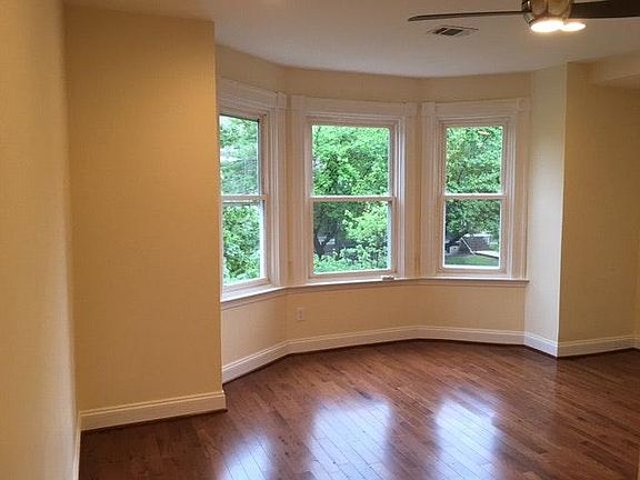 Bedroom with bay window and wood floors