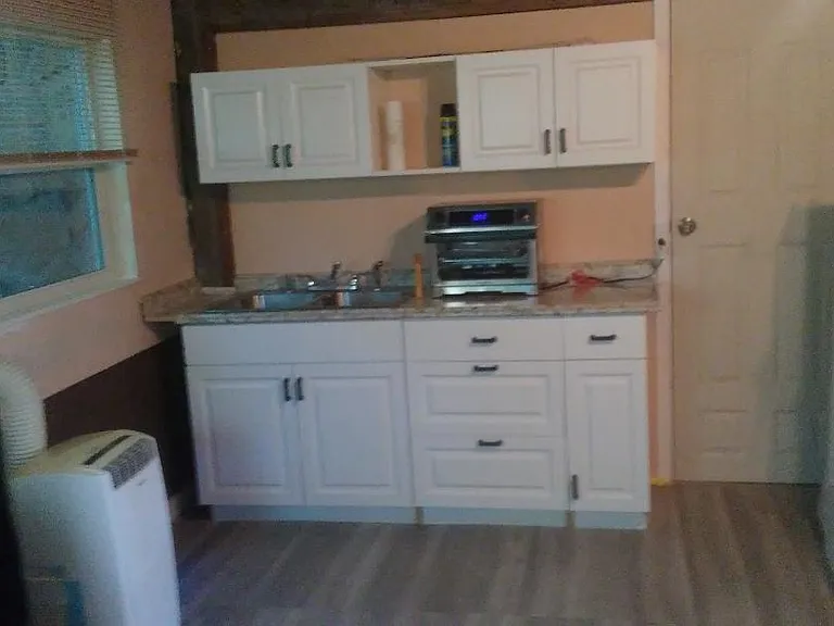 unit 100 :Kitchen, ac, fridge, door to bathroom,