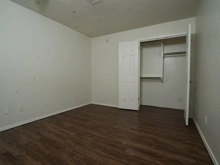 Bedroom 2: Mid-size room with updated flooring and ample closet space