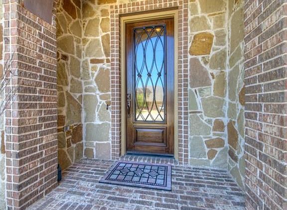 Welcoming front entry with tall wood door