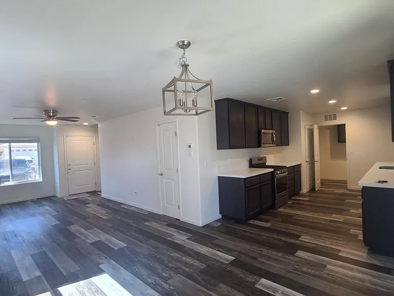 View from dining room into kitchen and towards front door.