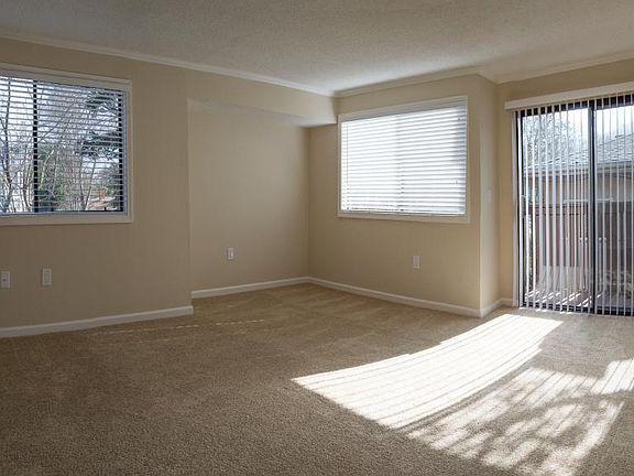 Brightly Lit Living Room Leads To Patio