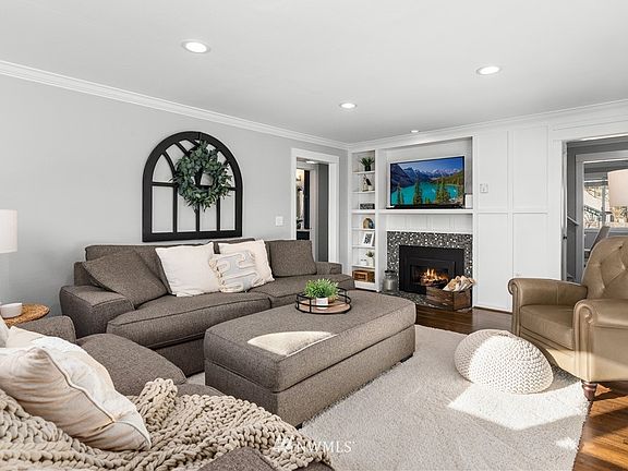 Comfortable living room with built-in cabinetry & natural gas fireplace.