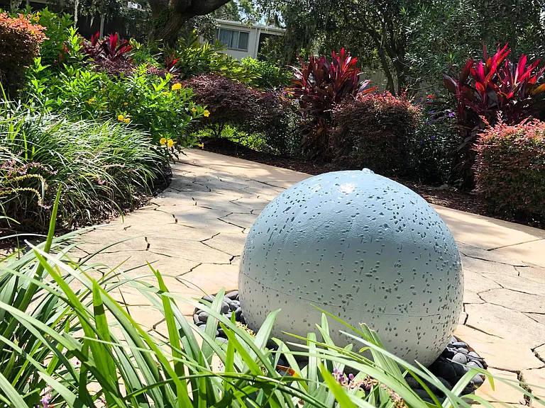 Find tranquility in our Zen Garden featuring a beautiful water feature and elegant tropical landscaping.