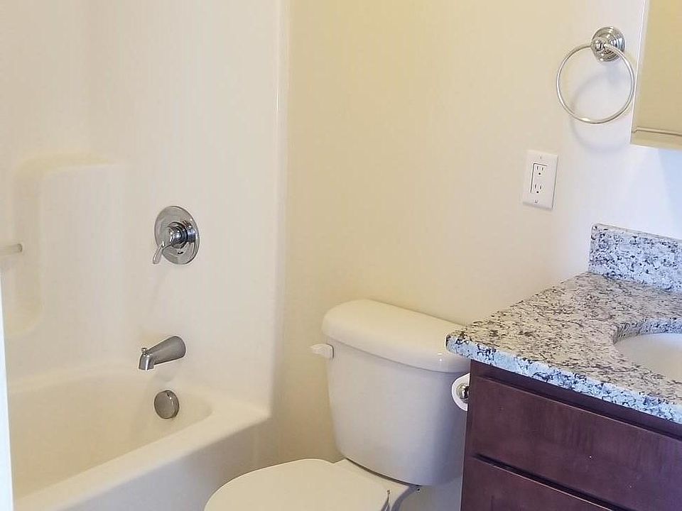 Bathroom with granite countertop, full bath and shower combo.