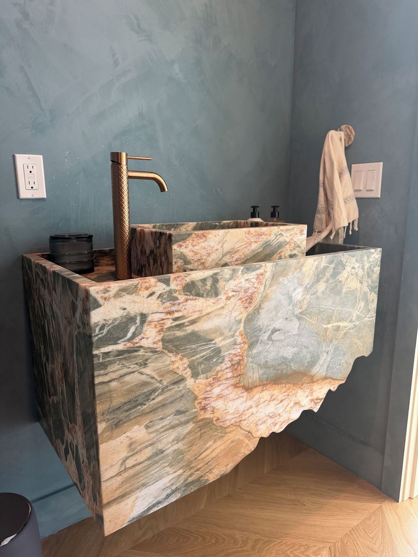  Powder room with custom marble sink to welcome your guests in style 