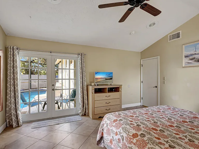 master bedroom, doors open into the pool area