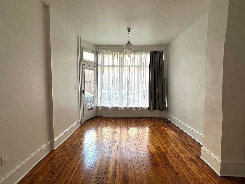 Living room with old storefront window. Room is 20'4" x 11'5".