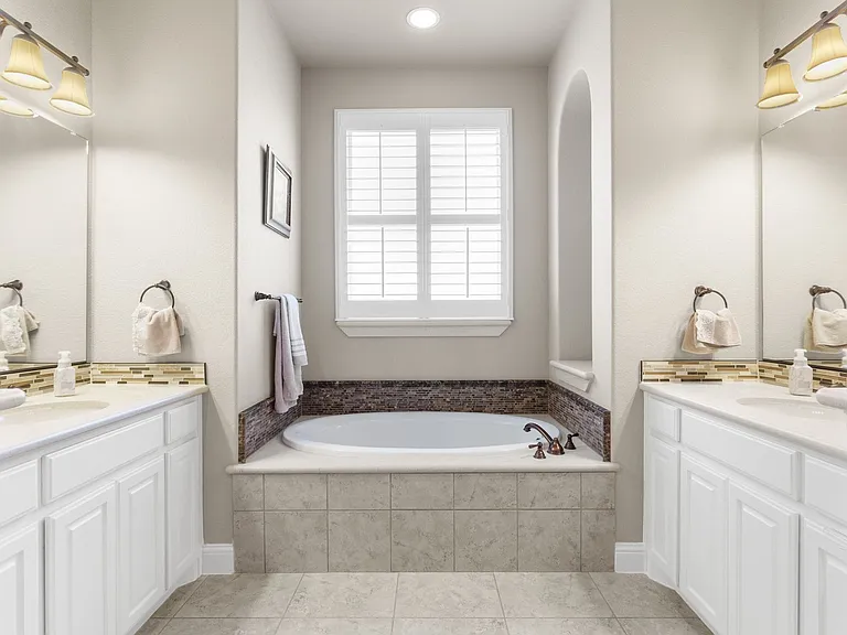 Sparkling clean primary bath also includes a custom outfitted walk-in closet.