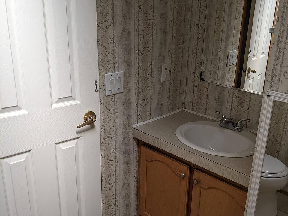 Bathroom vanity/sink. Storage under vanity/mirror above. Skylight in this room.