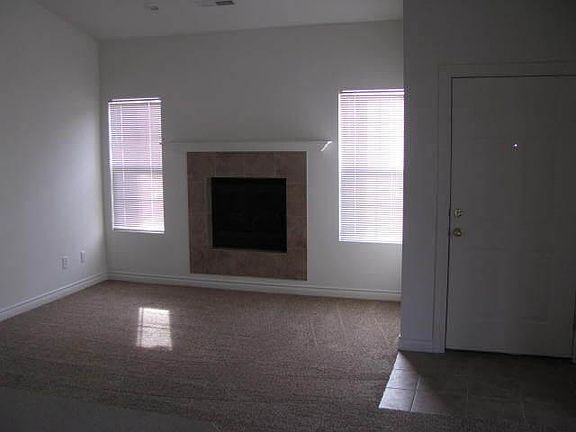 Living room, electric fireplace, and front entrance.