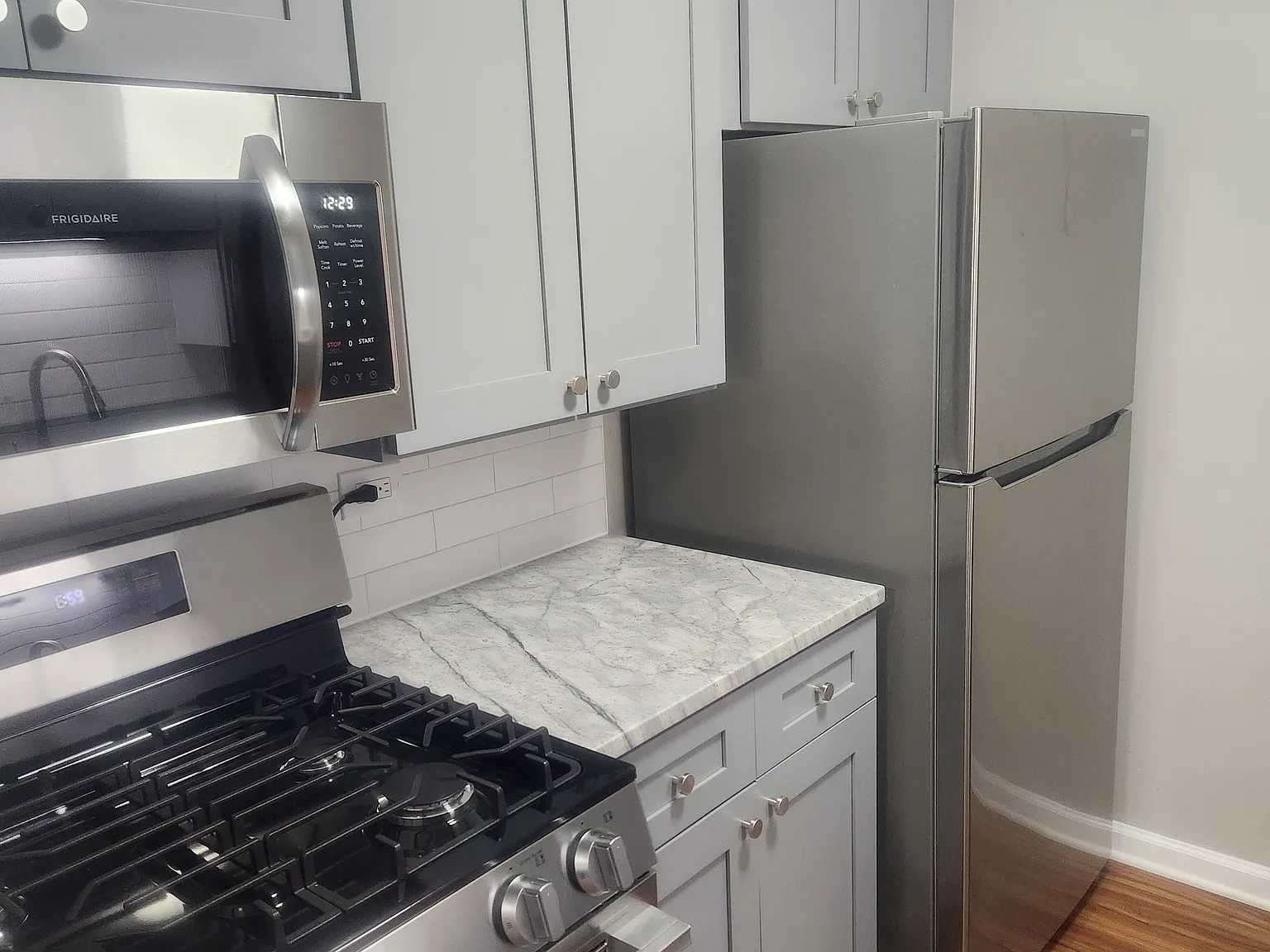 Brand new gas stove, microwave, cabinets, counter tops and fridge