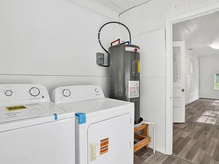 New washer dryer in laundry room with cabinets.