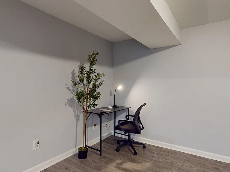 Bonus flex space with durable plank flooring and a compact desk setupideal for a home office or study nook.