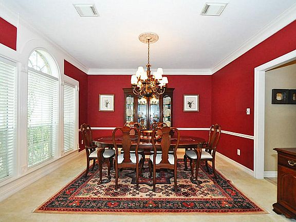 Formal dining has large windows bringing the outside in.