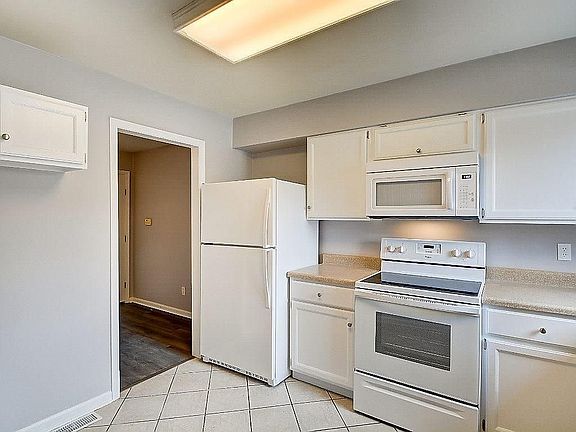 View of microwave and fridge