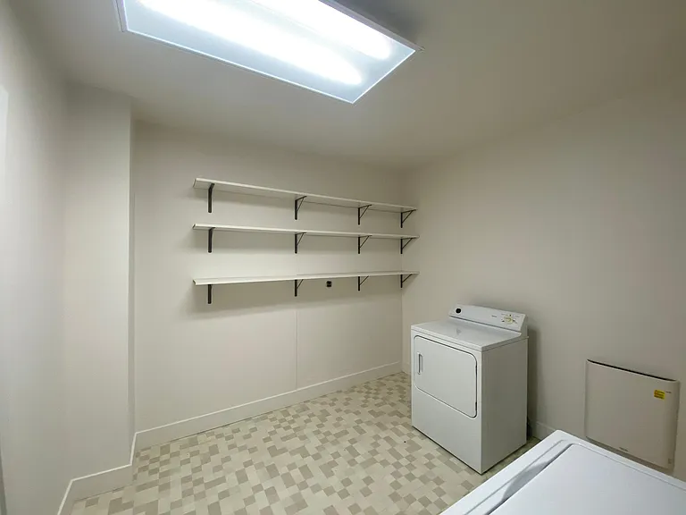 The newly remodeled Laundry Room with full size washer and drier. Lots of storage space.