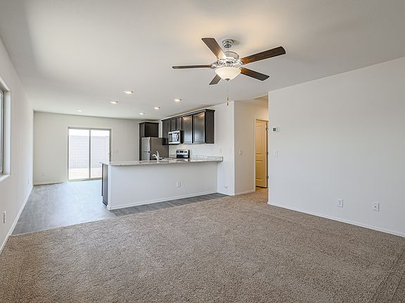 Large family room with a ceiling fan, connect to the kitchen.
