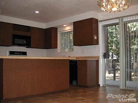 Kitchen is equipped with built in microwave, dishwasher, garbage disposal, range & refrigerator. Large dining area in kitchen.