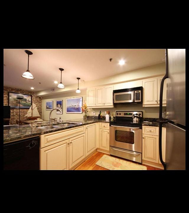 Kitchen with stainless steel appliances, marble counter tops