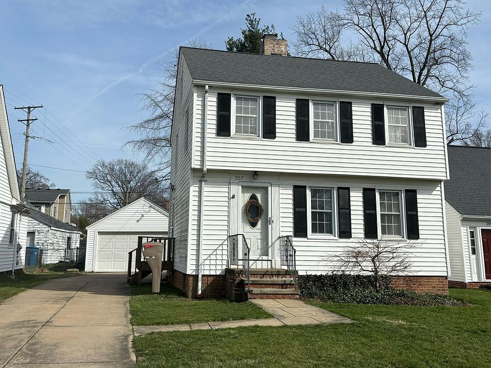 Main entrance and 2-car detached garage.