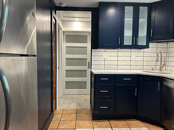 Fully New Kitchen, Refrigerator on Left, (Center) Contemporary Primary Bedroom Privacy Door