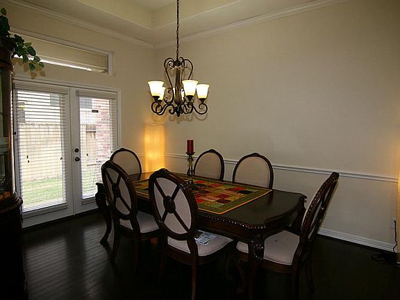 Formal Dining room with nice chandelier, hardwood floors.