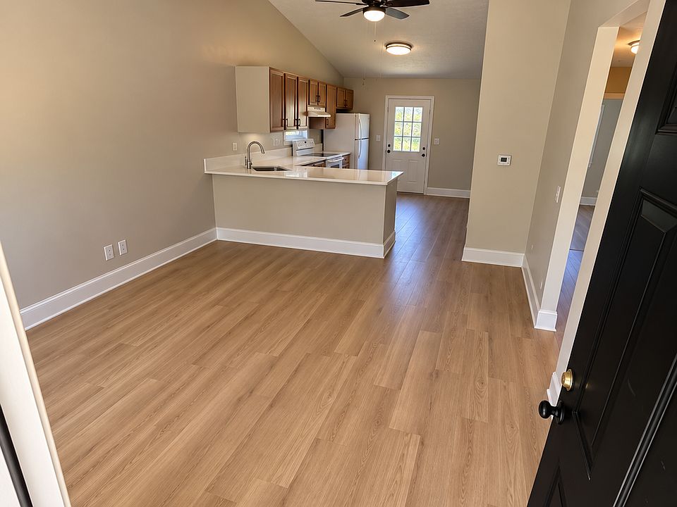 Open concept living and kitchen areas with vaulted ceilings