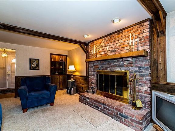 FIRST FLOOR FAMILY ROOM WITH WOOD BURNING FIREPLACE AND WET BAR