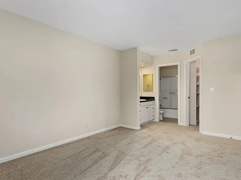 Adjoining bathroom to large bedroom.
