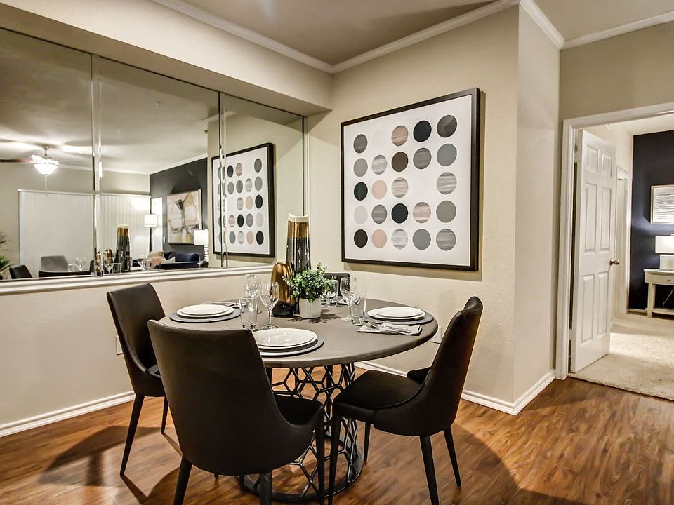 Cozy dining nook with hardwood style flooring, crown molding and wall mirror
