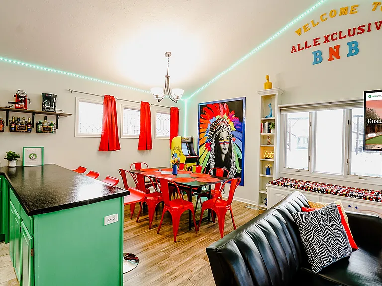 A dining area accented with striking red chairs and a wide table, inviting memorable meals and conversations in a sophisticated setting