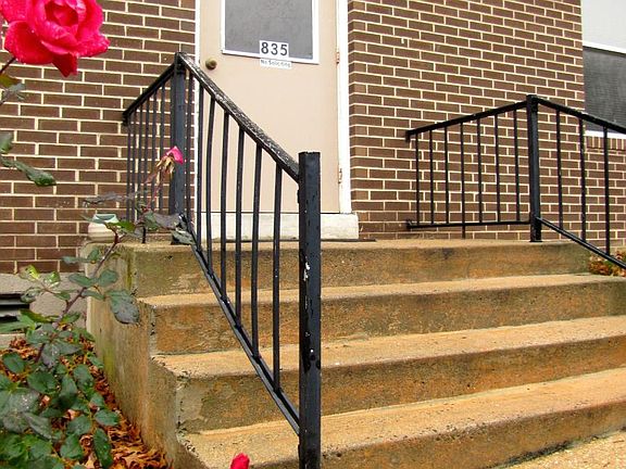 The entrance to your building is flanked by two beautiful rose bushes!