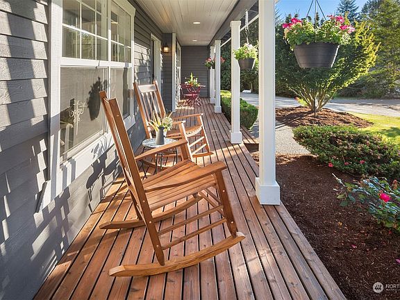 Covered front porch which wraps around side of home>