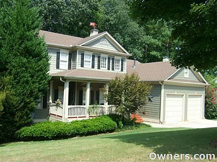 Front of Home with Rocking Chair Front Porch & Double Garage